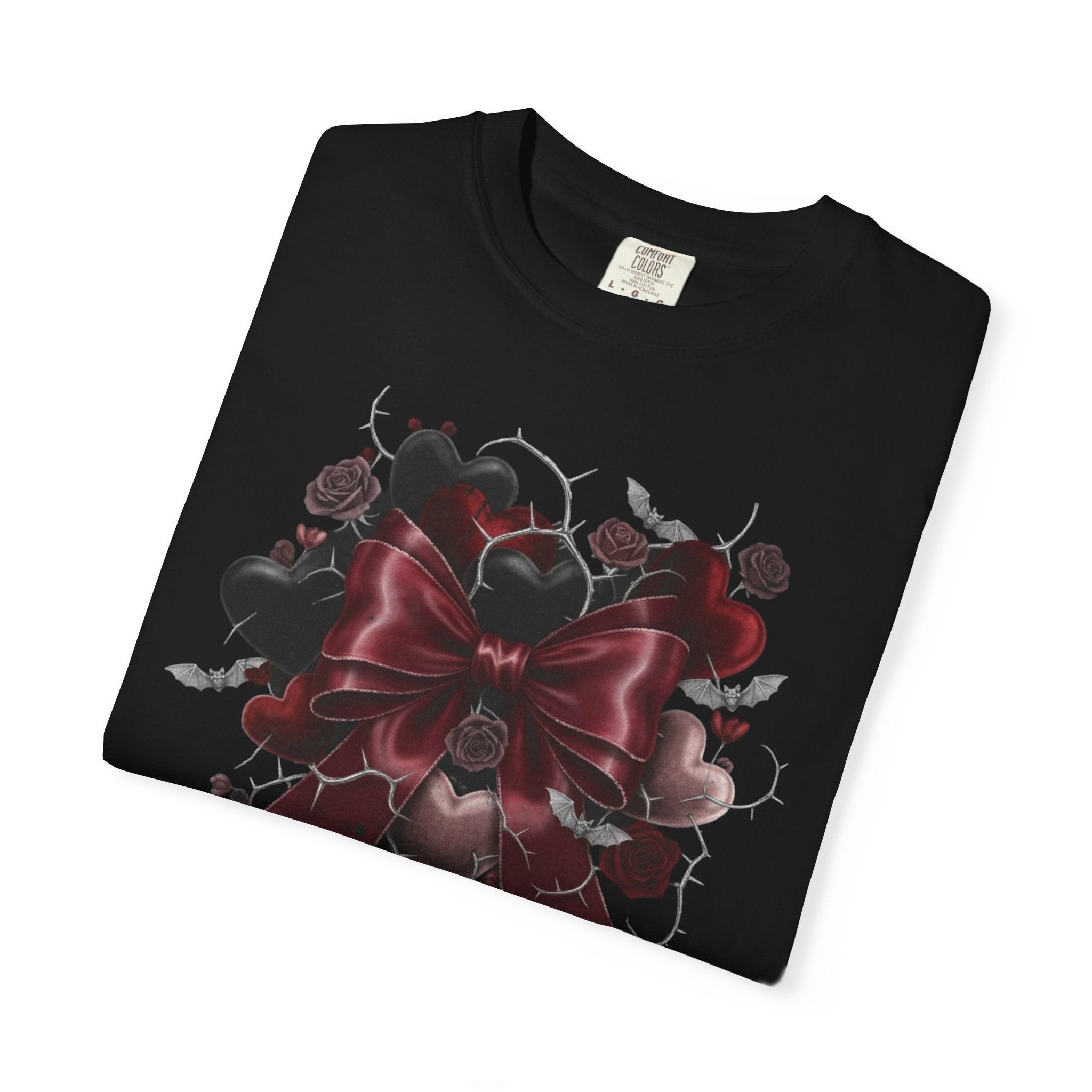 Black t-shirt with a red bow and floral design on a white background