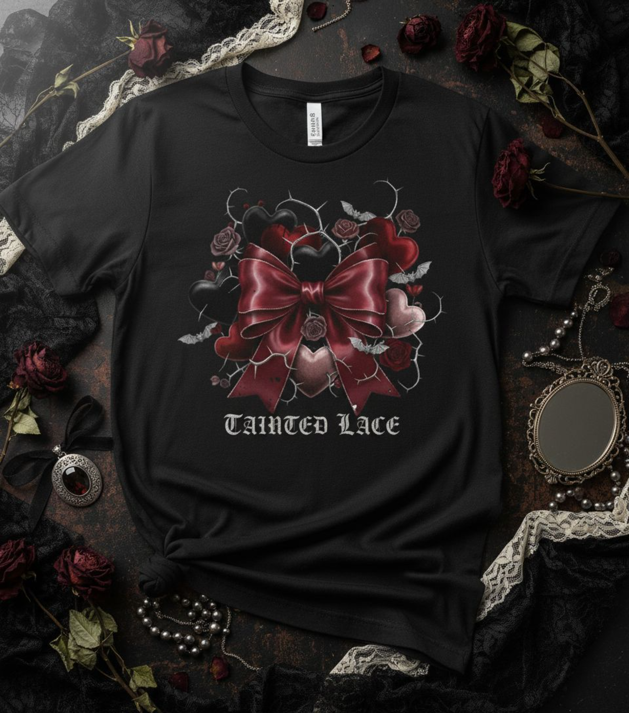 Black t-shirt with a red bow design and 'Tainted Lace' text on a dark background with roses and lace.