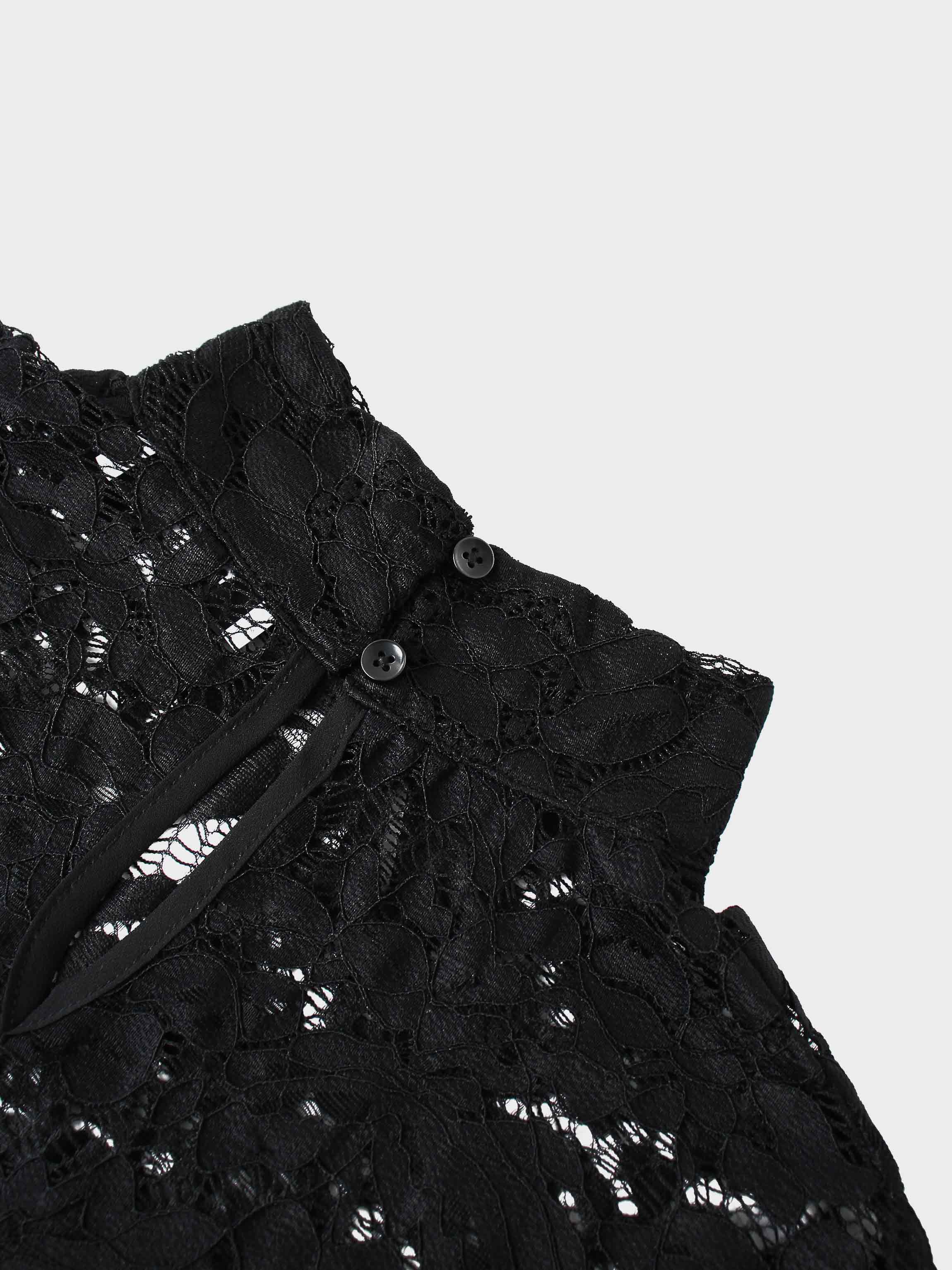 Black lace garment with buttons on a light gray background
