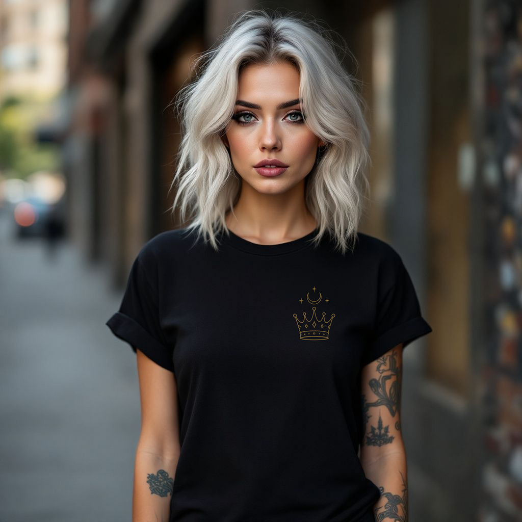 Woman wearing a black t-shirt with a crown emblem on a city street.