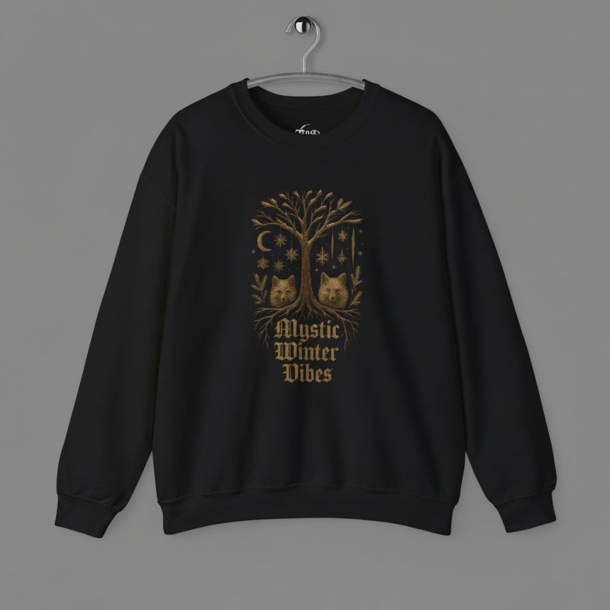 Black sweatshirt with a tree design and 'Mystic Winter Vibes' text on a gray background