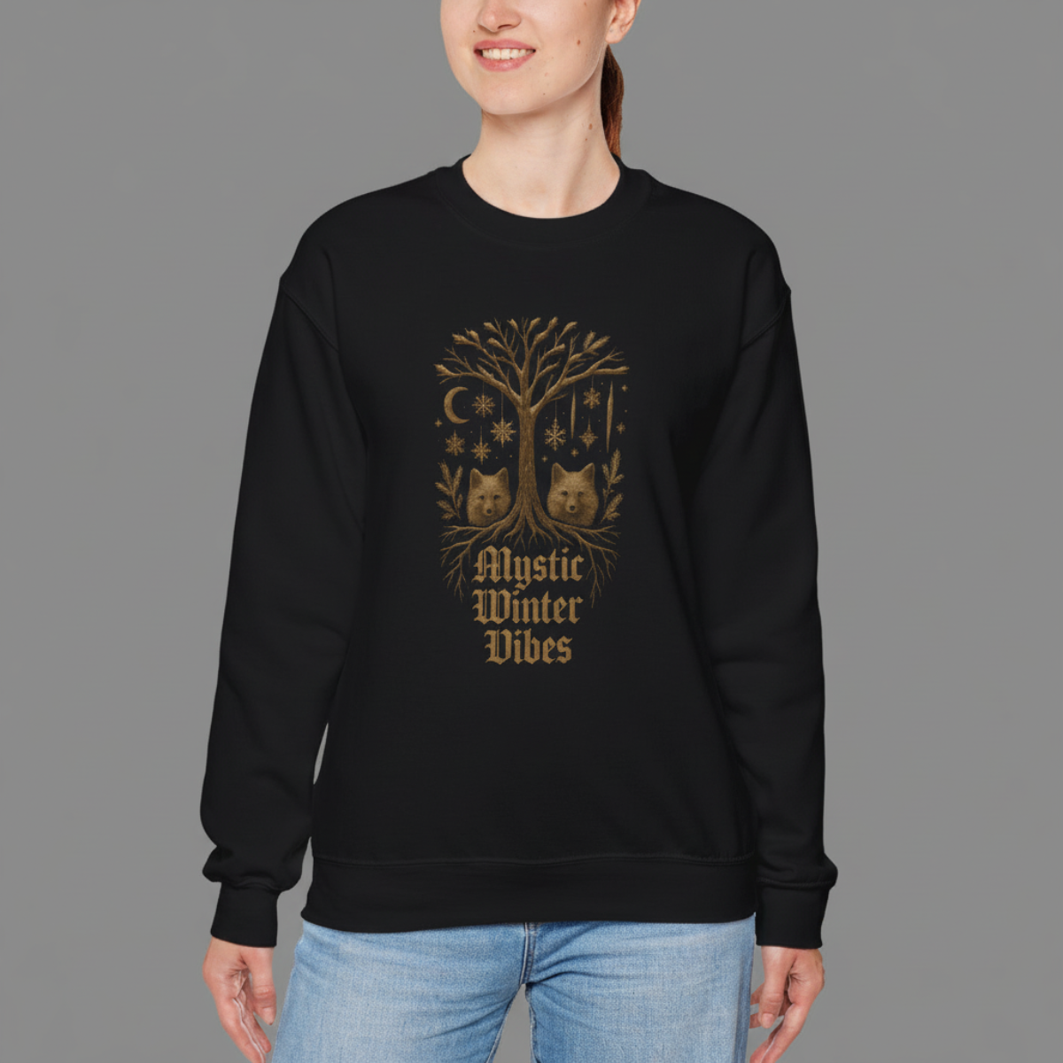 Person wearing a black sweatshirt with a gold tree design and text on a gray background