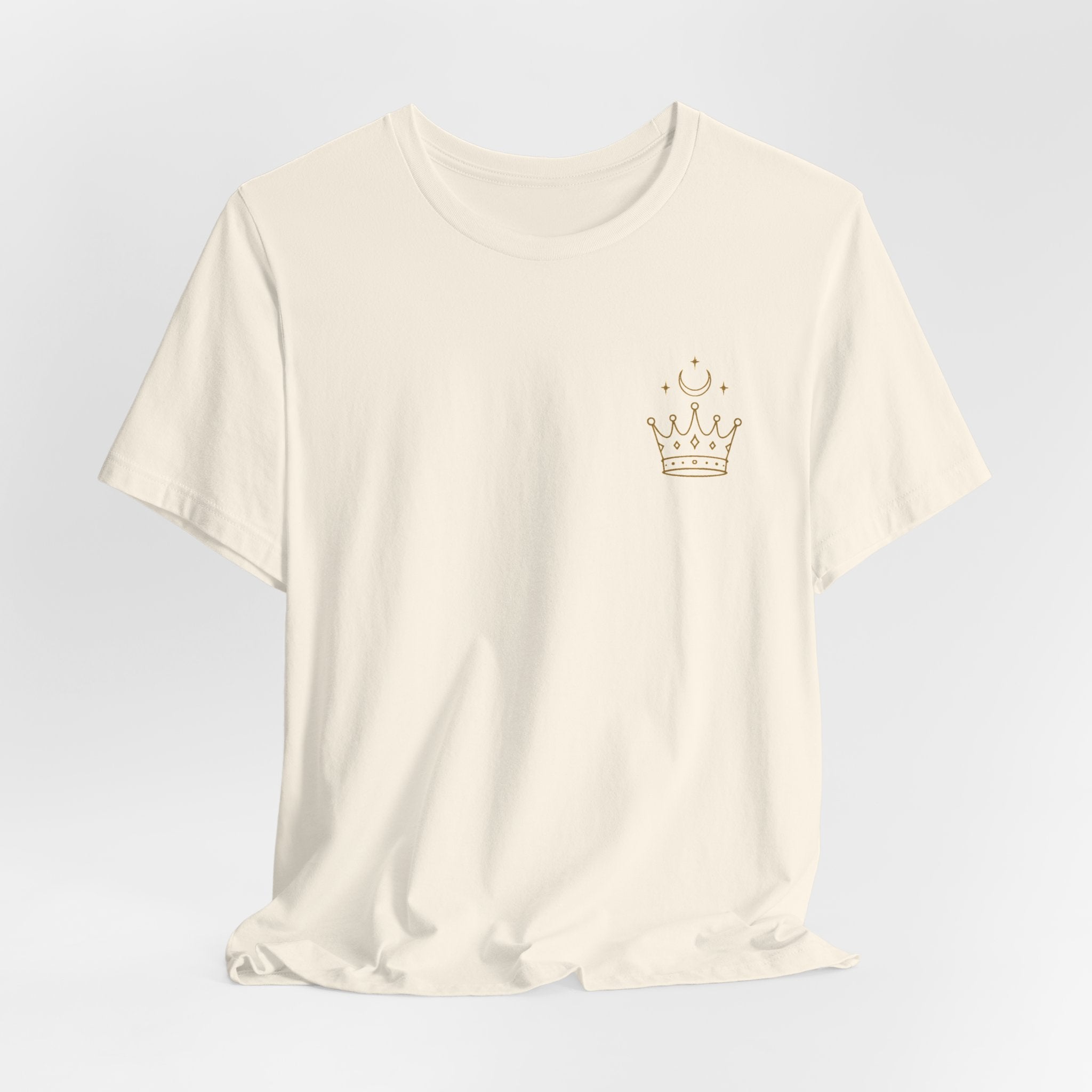 White t-shirt with a gold crown design on a light gray background
