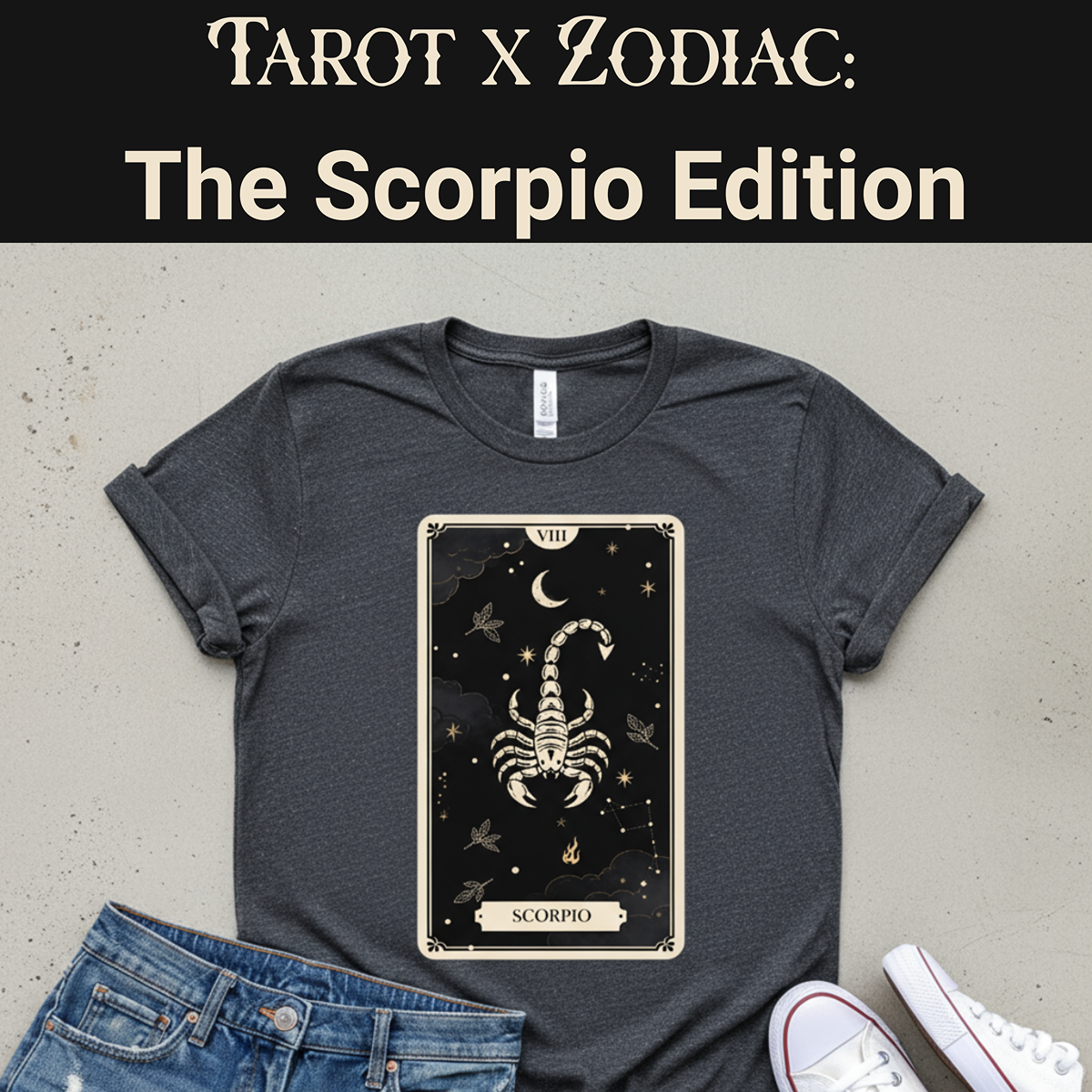 Gray t-shirt with Scorpio tarot card design on a concrete surface with jeans and shoes.