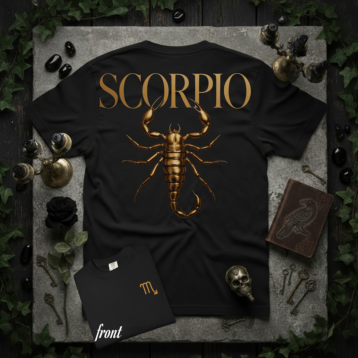 Black t-shirt with gold Scorpio design on a stone surface with decorative items.