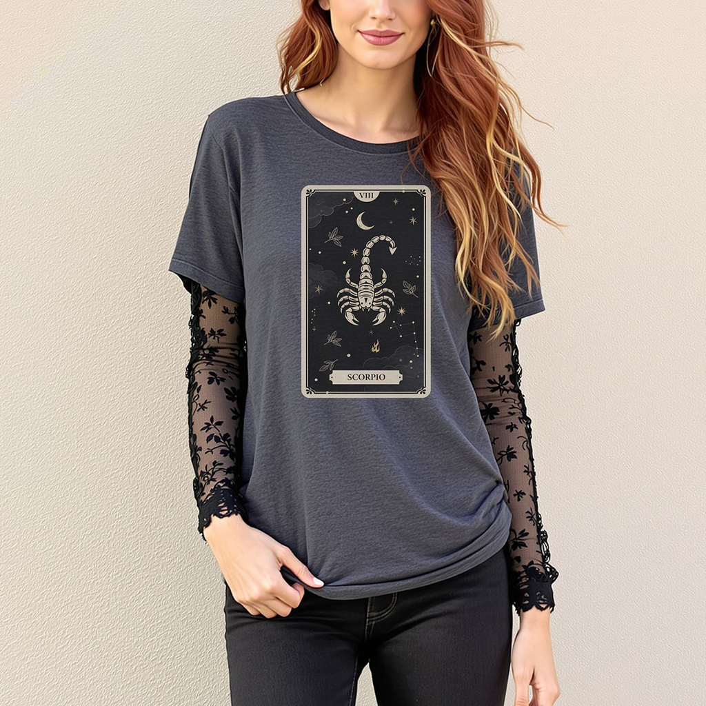 Woman wearing a dark blue t-shirt with a Scorpio zodiac card design on a plain background