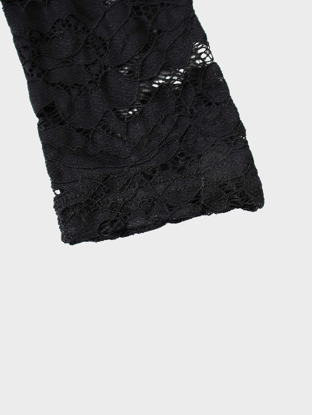 Black lace fabric on a white background