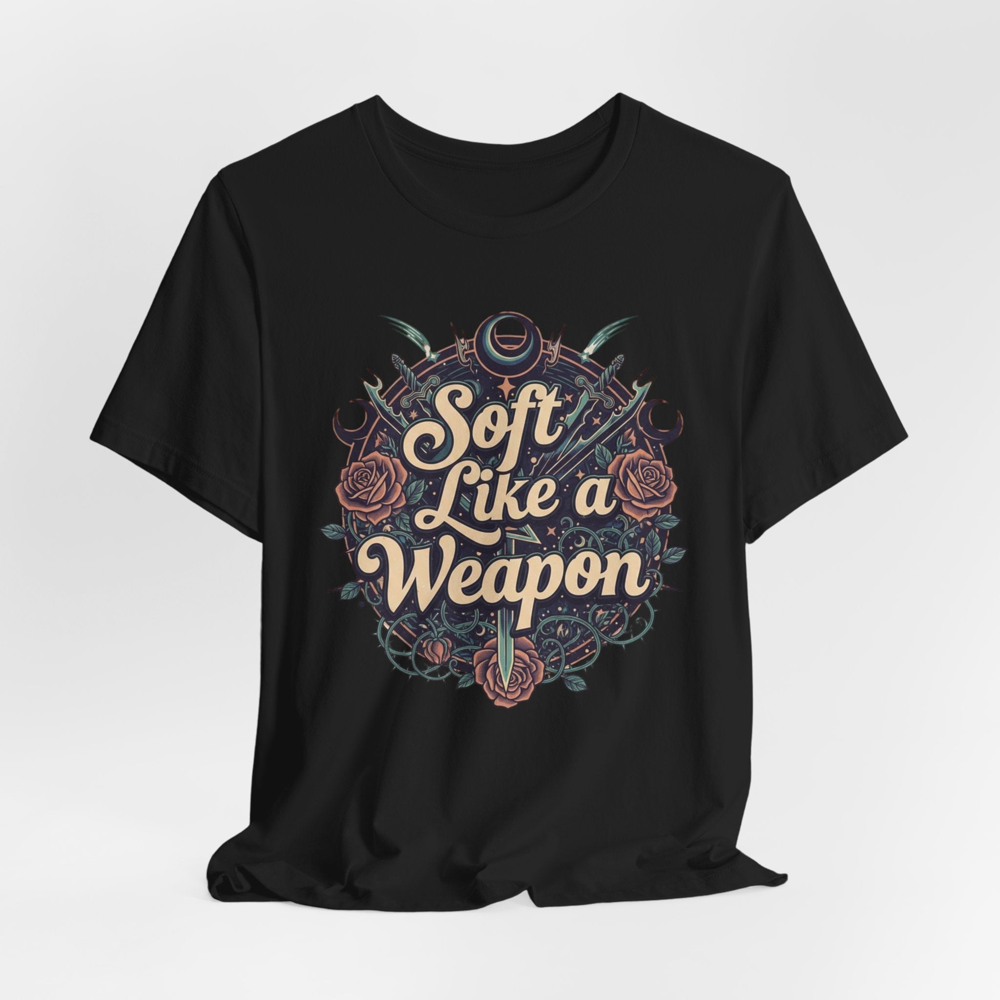 Black t-shirt with 'Soft Like a Weapon' graphic design on a white background