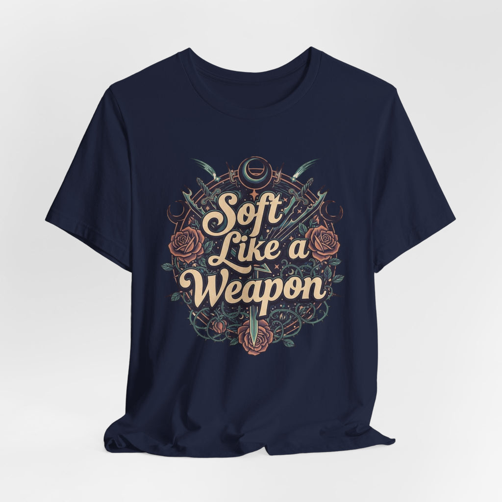 Navy blue t-shirt with 'Soft Like a Weapon' text and design on a light gray background