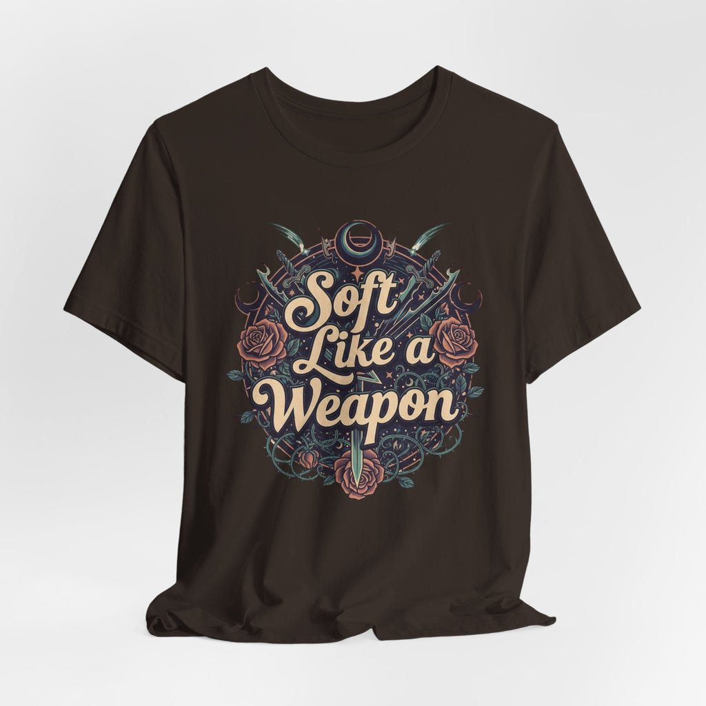 Black t-shirt with 'Soft Like a Weapon' text and decorative elements on a white background