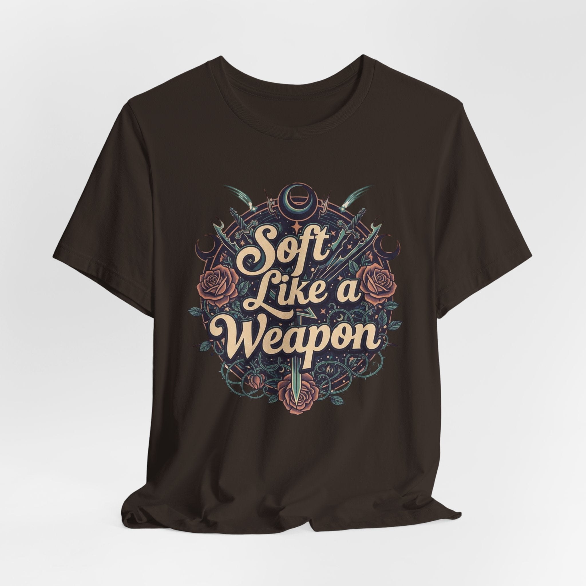 Black t-shirt with 'Soft Like a Weapon' text and decorative elements on a white background