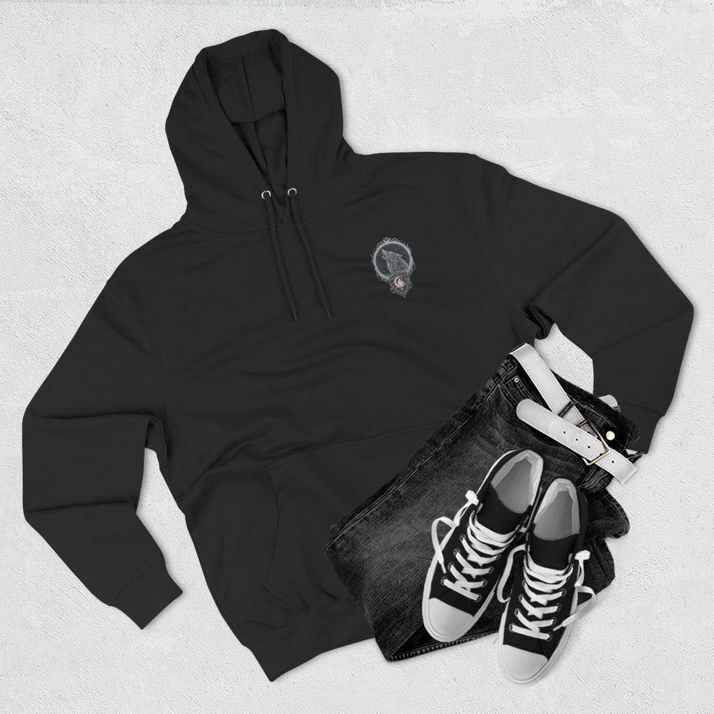 Black hoodie with a small logo, black jeans, and black sneakers on a light gray background